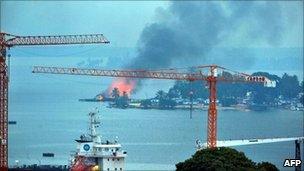A pro-Gbagbo naval base in Abidjan burns after UN and French air strikes, 10 April