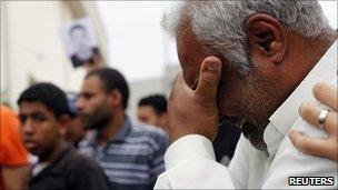 A relative of Ali Issa Saqer cries during his funeral in Manama, 10 April