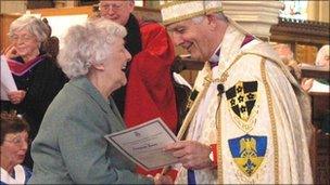 Georgina Jones receiving her award from the Archbishop of Wales