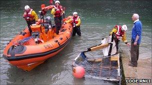 Looe lifeboat with retrieved section of the Norvik. Pic: Looe RNLI
