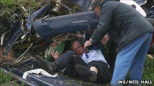 Nigel Farage getting out of the aircraft after it crashed in Northamptonshire
