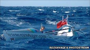Roz Savage waving from her boat in the Atlantic in 2005