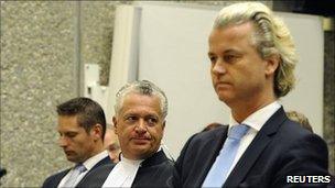 Geert Wilders (R) and his lawyer Bram Moszkowicz (C) in court in Amsterdam on 13 April 2011