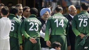Indian Prime Minister Manmohan Singh, centre back, and Pakistan Prime Minister Yousuf Raza Gilani, fourth from left at back, shake hands with Pakistan players ahead of the Cricket World Cup semi-final match between India and Pakistan in Mohali, India, on March 30, 2011.