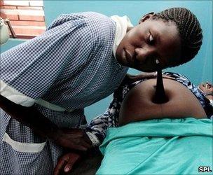 A pregnant mother is examined in a clinic