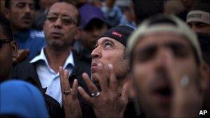 Demonstrators attend a protest in central Tunis on 1 April 2011