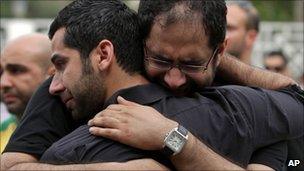 Relatives grieve at the funeral of Karim Fakhrawi, 13 April in Manama