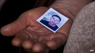 Mohamed Bouazizi's mother holds a photo of her late son in the town of Sidi Bouzid, Tunisia, 8 March