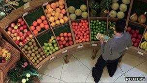 Man looks at fruit in a London store