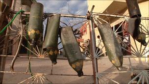 Apparent remnants of cluster bombs hang from a rebel barricade in Misrata