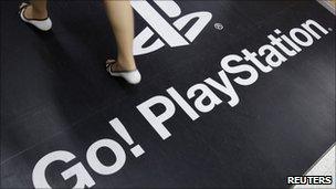 Woman walking on PlayStation logo, Reuters