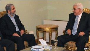 Palestinian Authority President and Fatah head Mahmud Abbas (R) talks to Hamas leader Khaled Meshaal