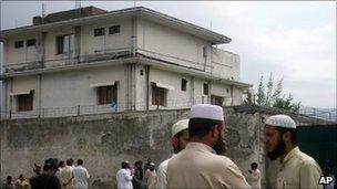 Local residents and media persons are seen outside the house of where al-Qaida leader Osama bin Laden was caught and killed in Abbottabad, Pakistan Thursday, May 5, 2011.
