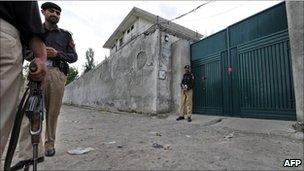 Pakistani policemen stand guard outside the hideout house of slain Al-Qaeda leader Osama bin Laden in Abbottabad on May 5, 2011.