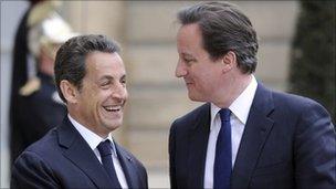 French President Nicolas Sarkozy welcomes British Prime Minister David Cameron prior to a working dinner focused on Libya's conflict on April 13, 2011 at the Elysee presidential palace, in Paris