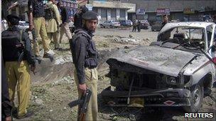Police stand at the scene of a suicide bomb blast in Dir, north-western Pakistan. Photo: April 2011