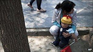 Chinese woman with child in Beijing (file image)