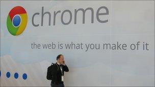 Man speaking on mobile walks past Chrome advert