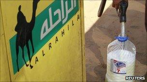 A Libyan pumps petrol into a bottle at a petrol station in Zawiyah, 30 miles (48 km) west of Tripoli