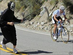 Spectator dressed as Grim Reaper at cycling road race