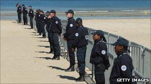 French police patrol the beach at the resort of Deauville on 25 May 2011