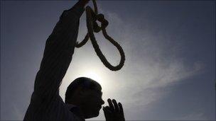 Egyptian protester waves a mock noose outside a Cairo courtroom