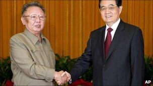 May 25, 2011 pic released by Xinhua, NK leader Kim Jong Il, left, shakes hands with Chinese President Hu Jintao