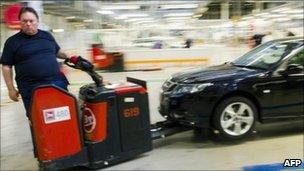 A Saab worker takes a car from the production line on 27 May