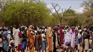 Women line up for food distribution in a makeshift camp for internally displaced people in the village of Mayen Abun, southern Sudan on Thursday May 26, 2011