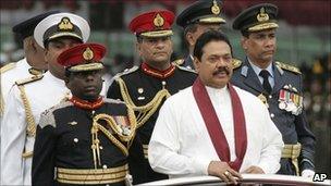 President Rajapaksa (wearing a scarf) inspects a guard of honour at the military festival