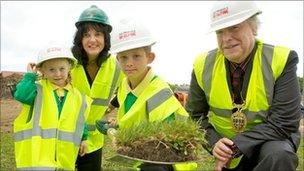 Two pupils help cut the first sod