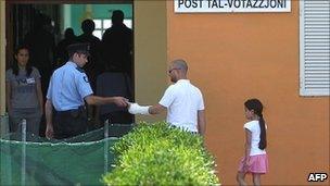 Maltese voters go to cast their vote in the referendum on 28 May 2011