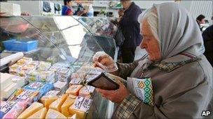 Belarusian woman buying cheese at a market in Minsk