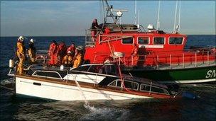 Sinking motorboat alongside lifeboat (Picture by Nicola Thomas)
