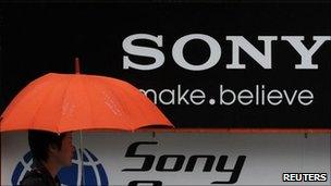 Man walks past Sony logo