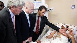 William Hague and Andrew Mitchell meet a casualty in a Benghazi clinic