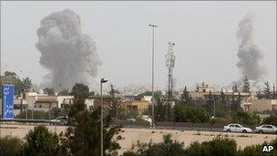 Smoke rises from an explosion after a Nato air strike in Tripoli, Libya, 7 June 2011