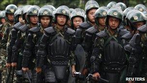 Riot police patrol on a street in the township of Xintang in Zengcheng near the southern Chinese city of Guangzhou June 13, 2011