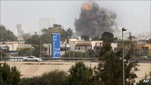 A smoke cloud rises after a Nato bombing in Tripoli