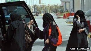 Saudi women enter car in defiance of a law banning female drivers