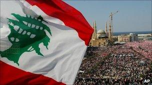 A Lebanese flag waves as thousands of protesters gather in Martyrs Square, central Beirut, Lebanon, March 14, 2005
