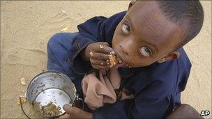 In this file photo of Thursday June 26, 2009, A Somali child eats as he is waiting to be registered at UN. registration centre in Dagahaley, Northeastern Kenya