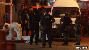 Police and forensic officers at scene of shootings in Monterrey, Mexico - 8 July 2011