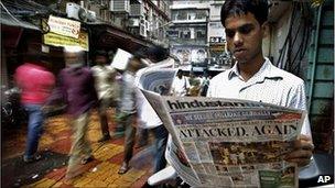 A man reads a newspaper at Zaveri Bazaar a day after the blasts in Mumbai on 14 July 2011