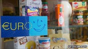 An old sign welcoming the Euro is seen on the window of a food shop near Accademia, Italy