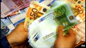 Cashier counting euro notes