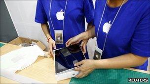 Staff in fake Apple store, Reuters