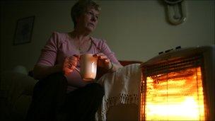 Pensioner by her electric bar fire