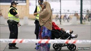 Norwegian police take the details of a Muslim woman near the Oslo train station after a bomb scare - 27 July 2011