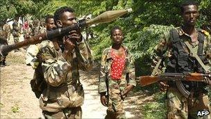 Somali government troops patrol sections of a front line in Mogadishu on 28 July 2011